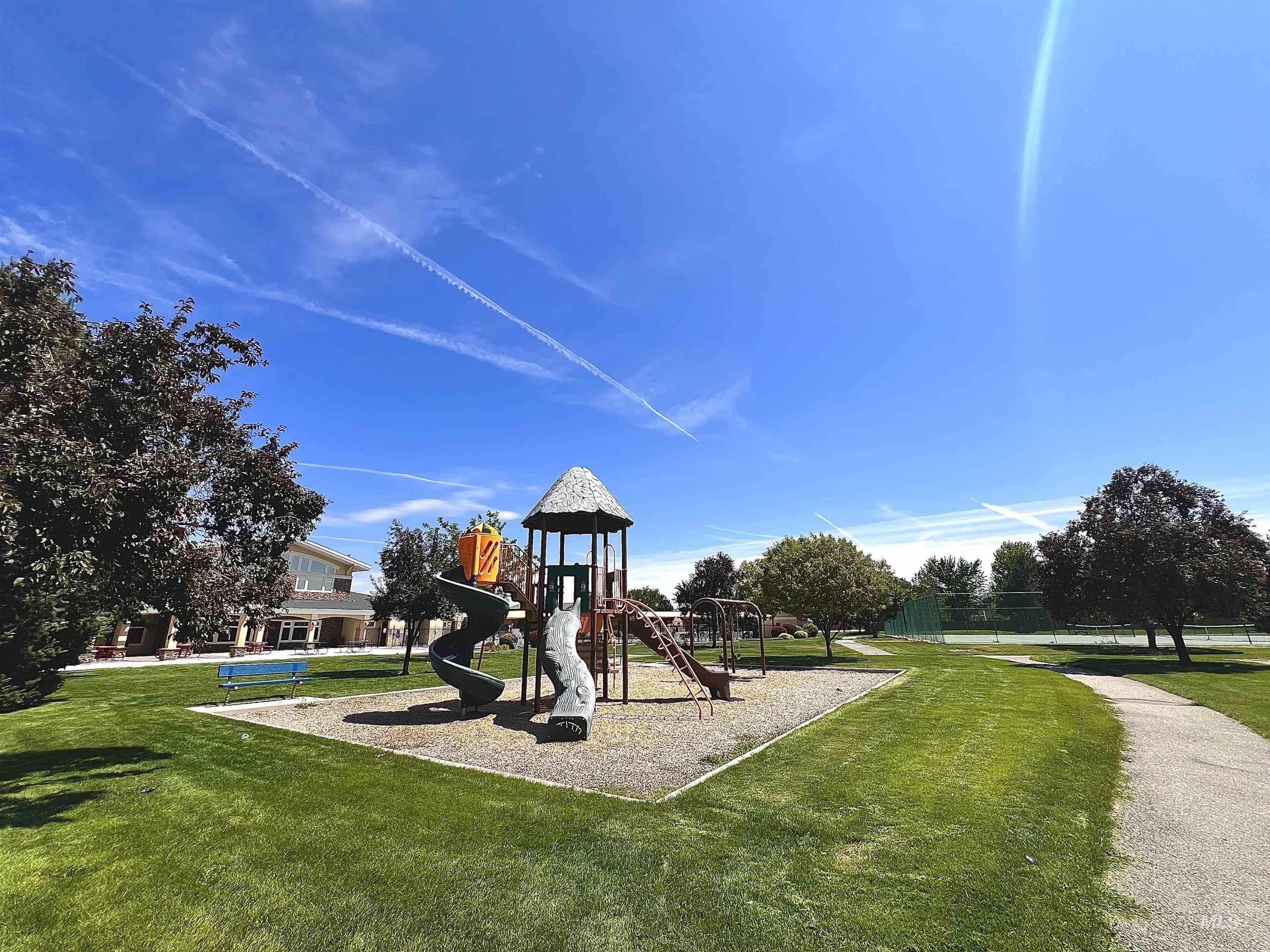 Community jungle gym featuring a lawn
