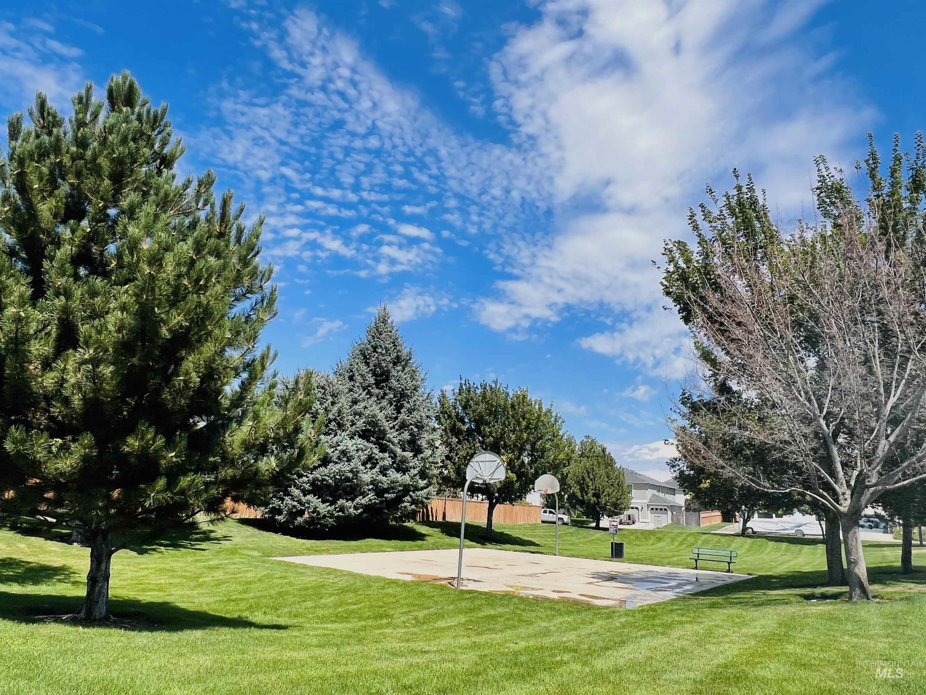 View of community with community basketball court and a yard
