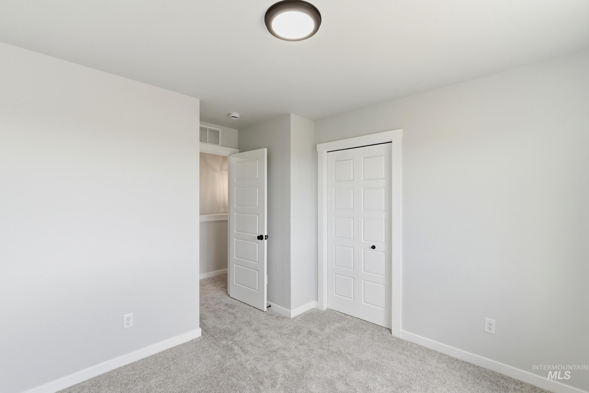 Neutral color palette with light gray carpeting and white trim