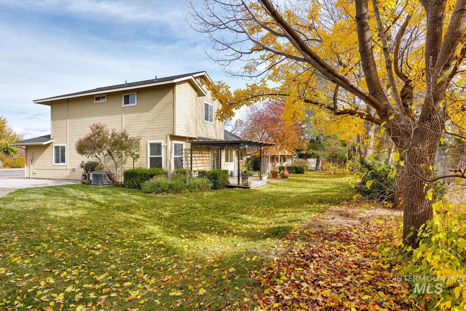 View of property exterior featuring a lawn and a patio