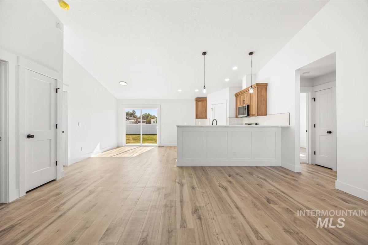 Unfurnished living room with light wood-style flooring and recessed lighting