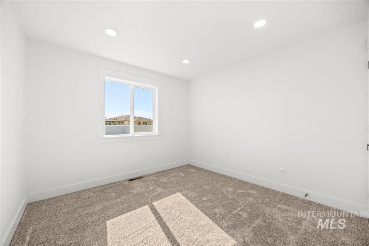 Spare room with carpet flooring and recessed lighting