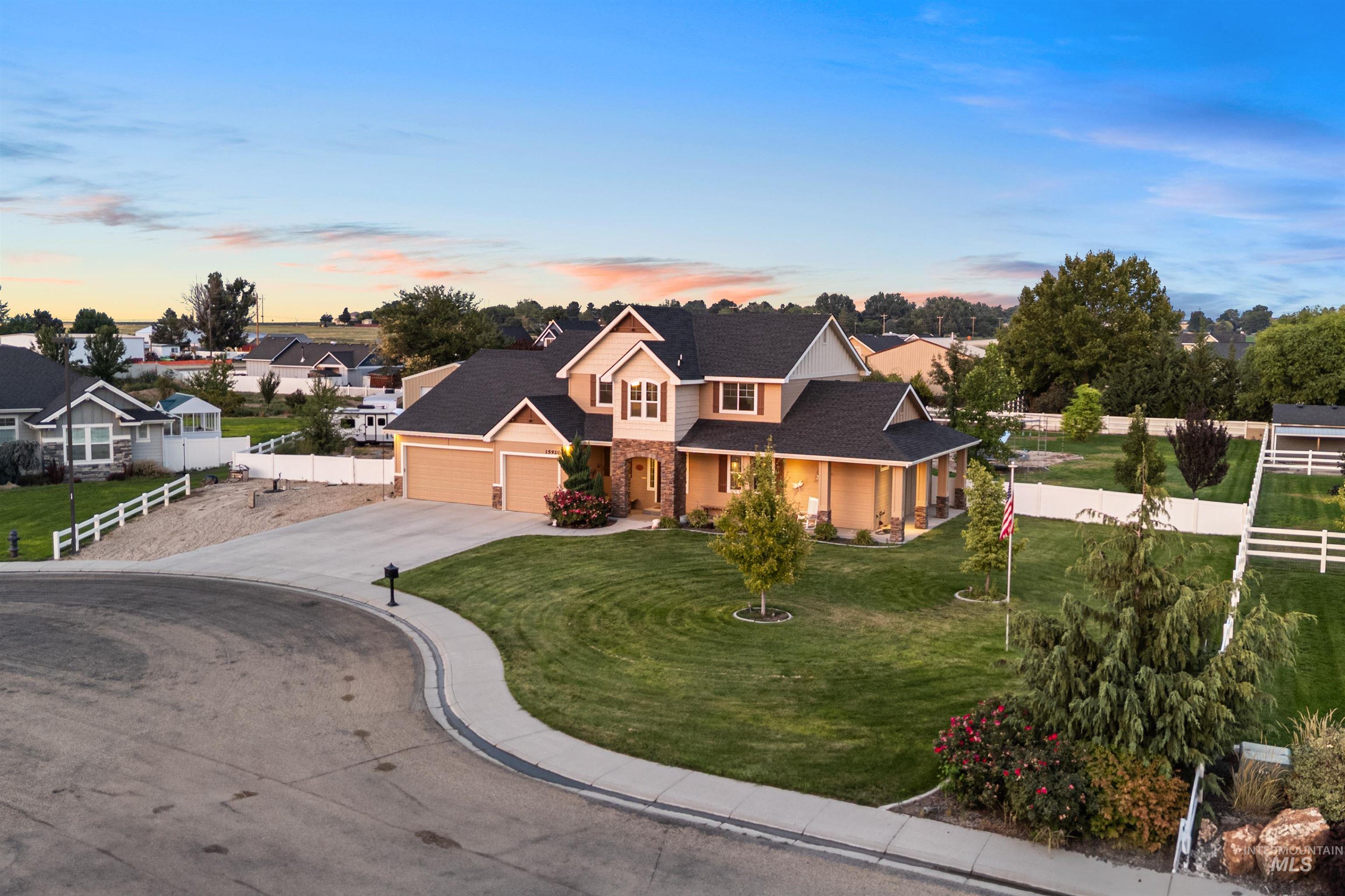 View of front of home with driveway, a porch, a garage, and roof with shingles