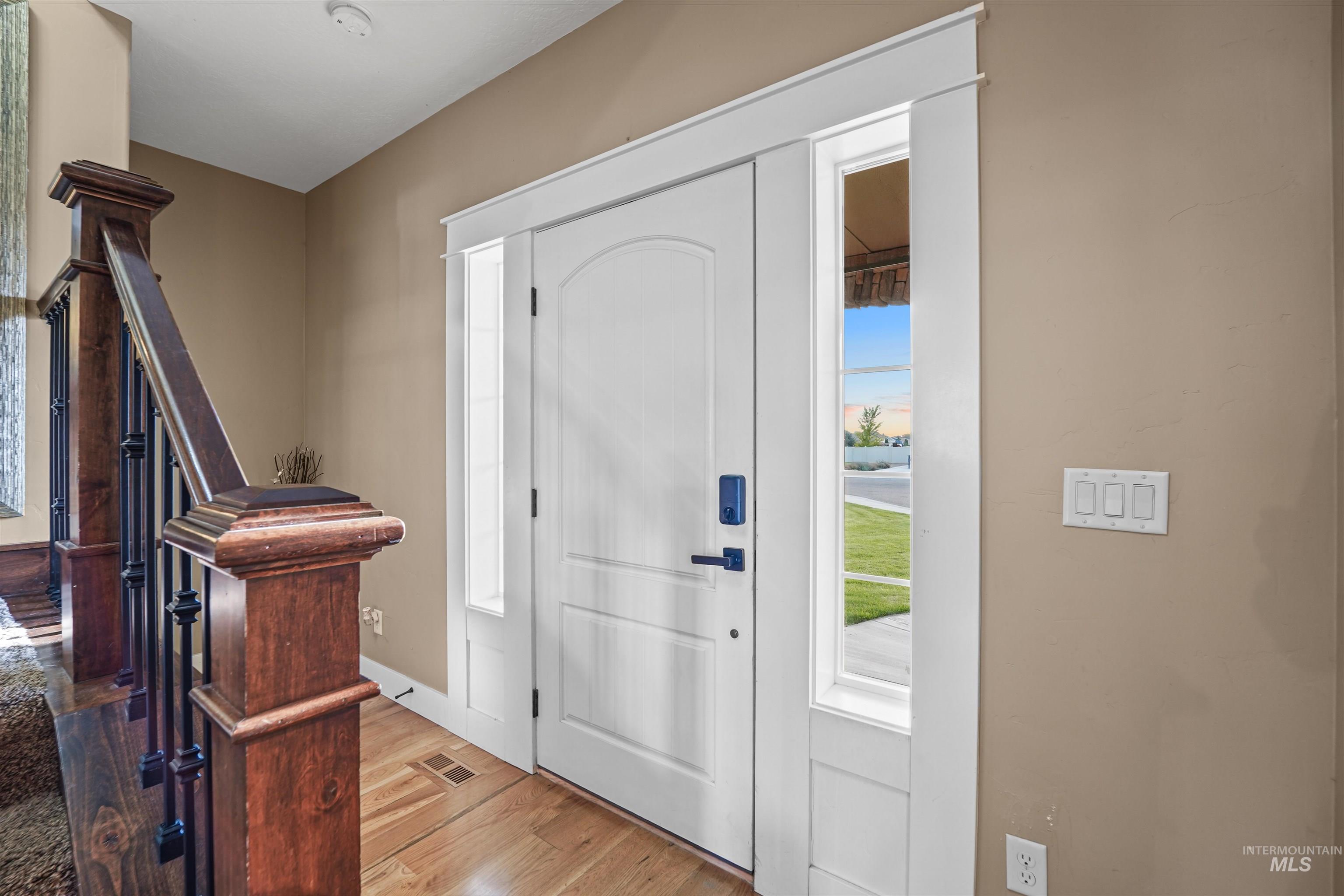 Foyer featuring light wood-style floors and baseboards