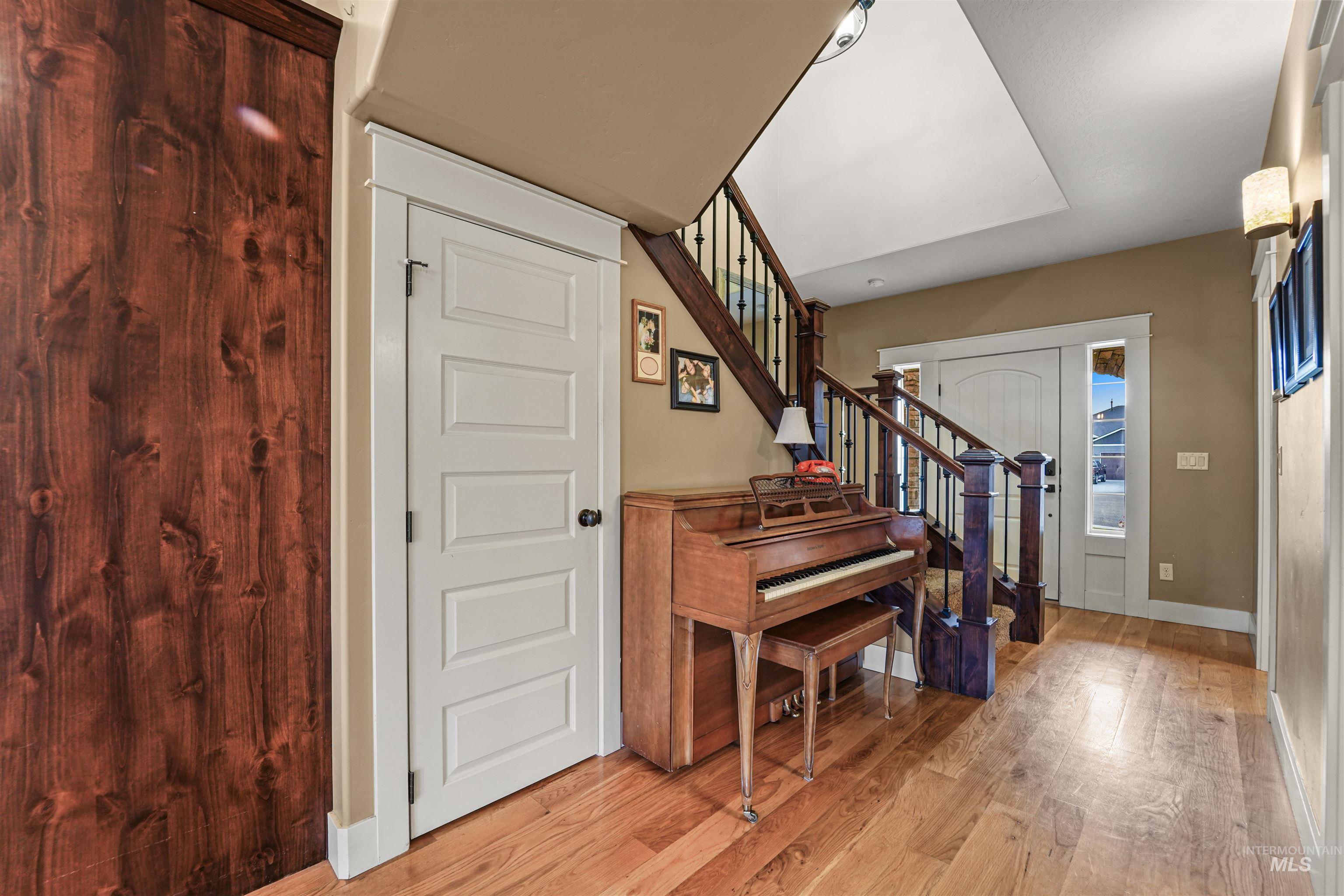 Foyer with light wood-style flooring and stairway