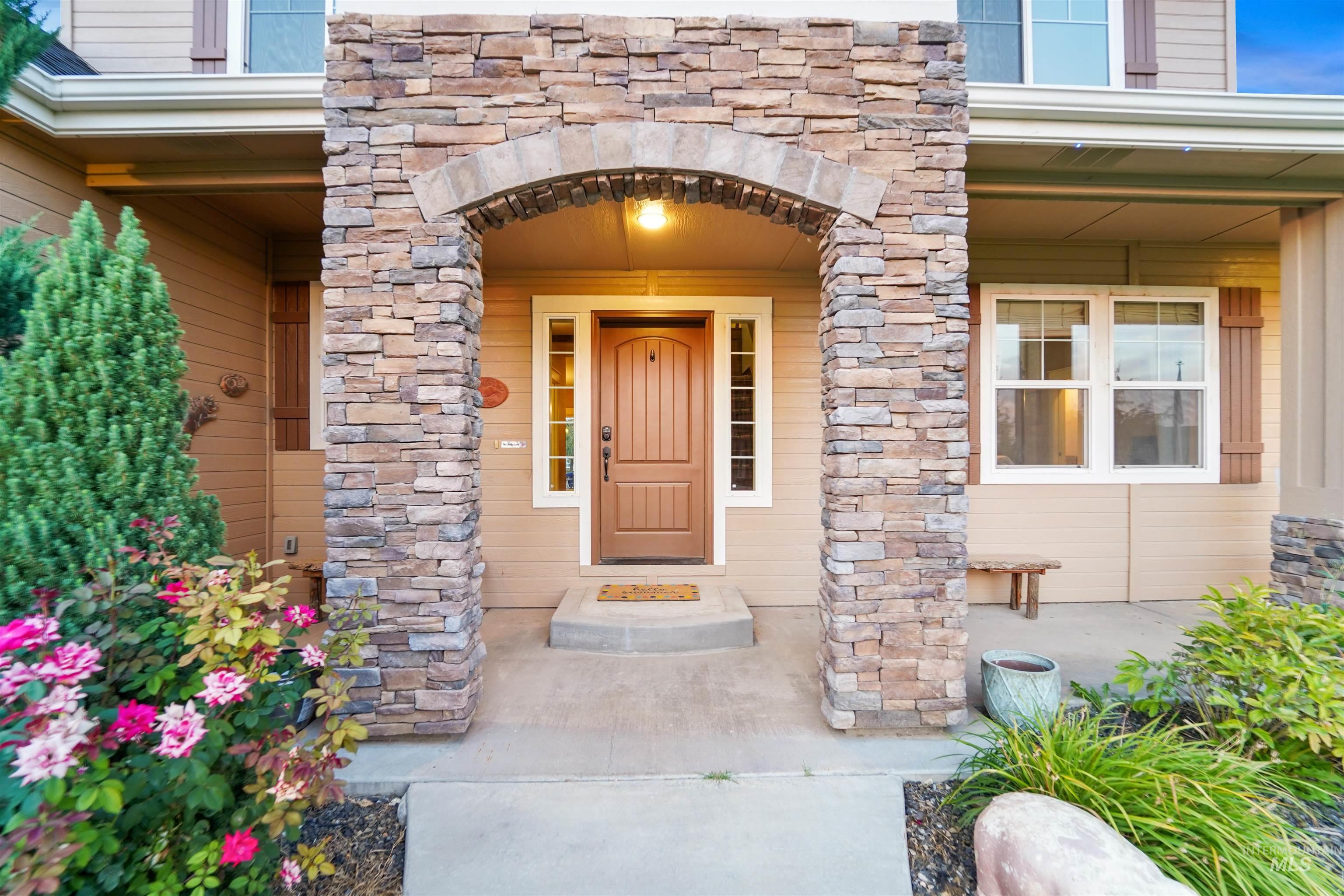 Property entrance featuring stone siding and a porch