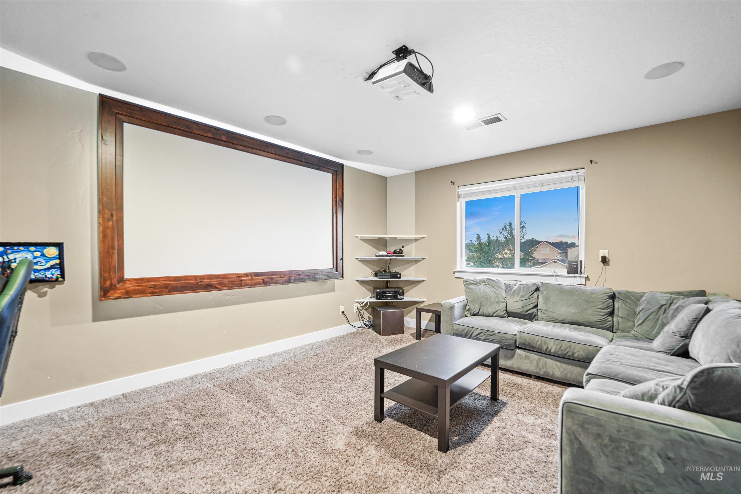 Cinema with baseboards and light carpet