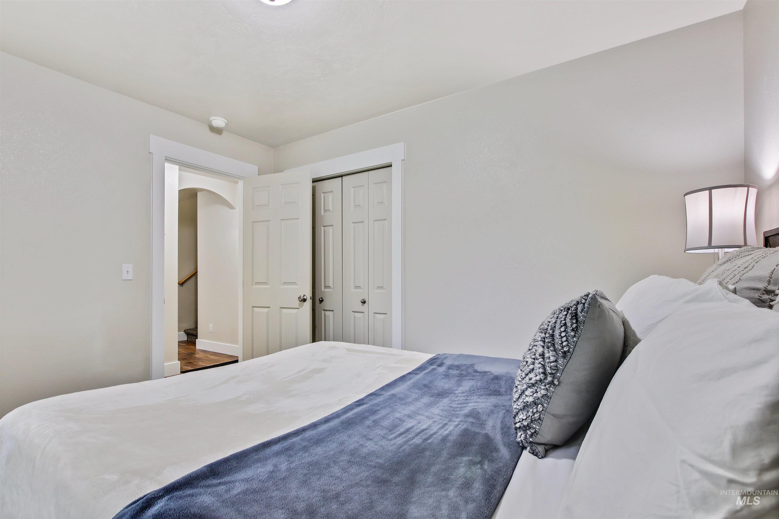 Bedroom with a closet and arched walkways