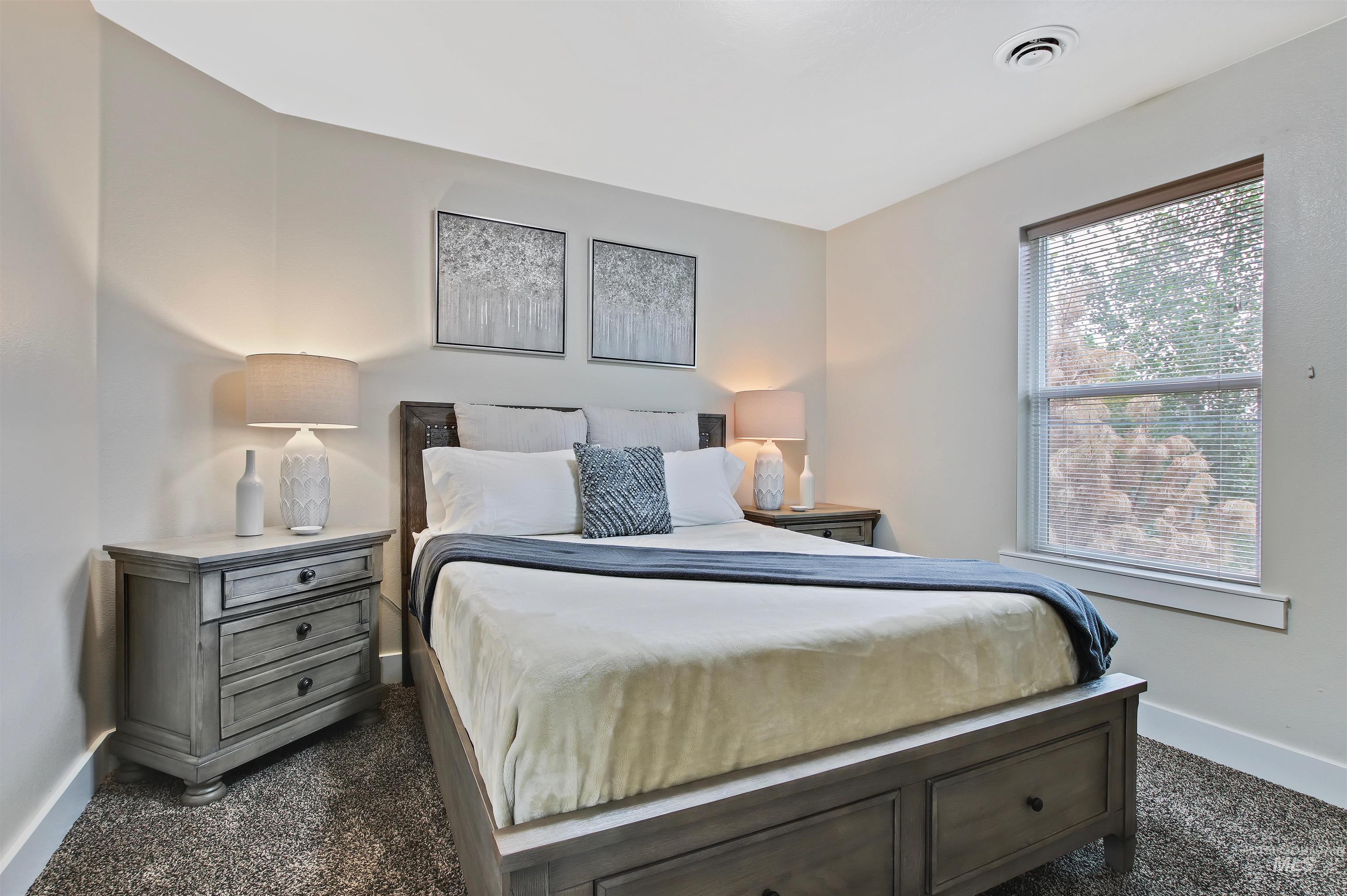 Bedroom with baseboards and dark carpet