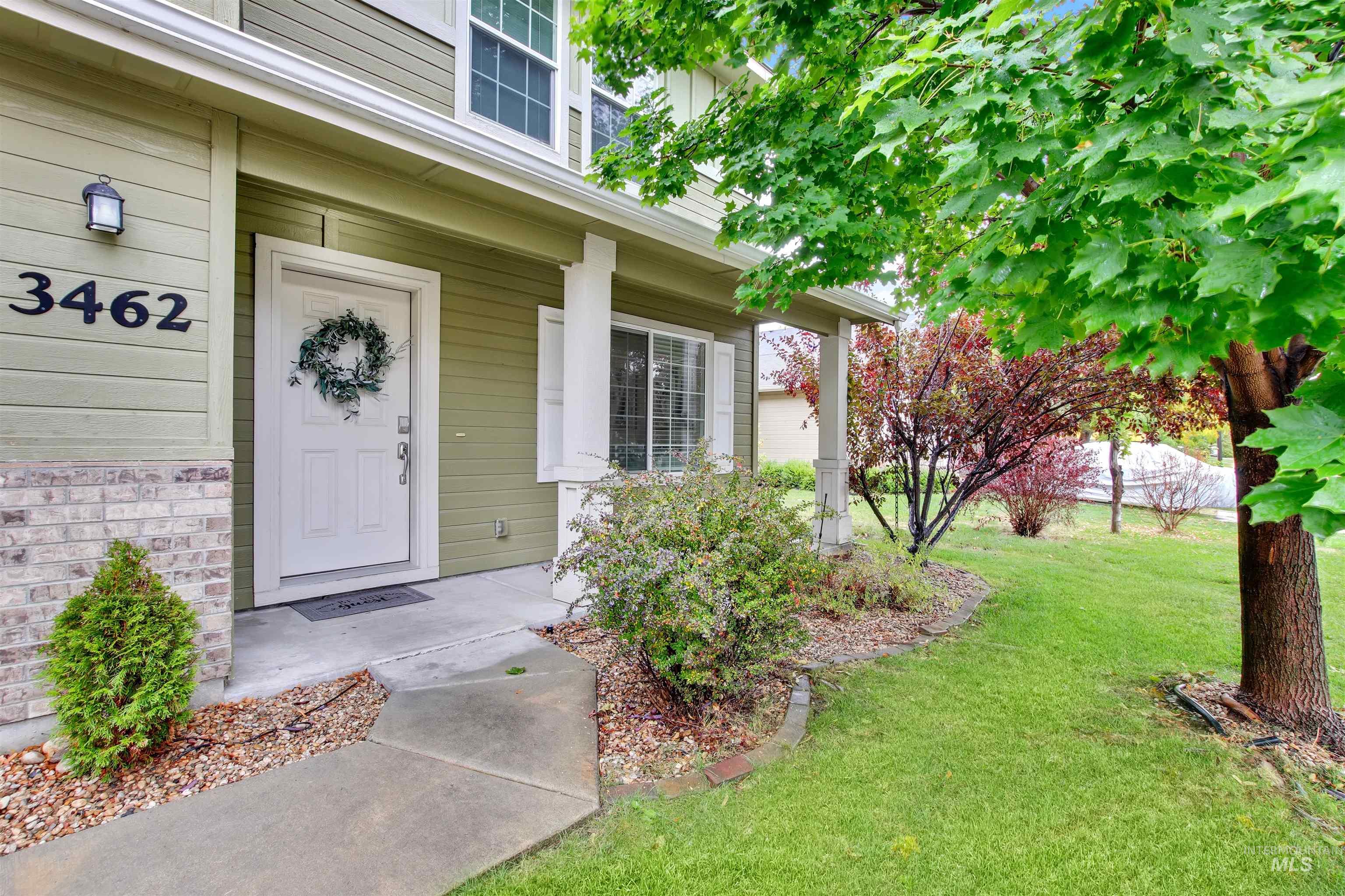 Doorway to property featuring a lawn
