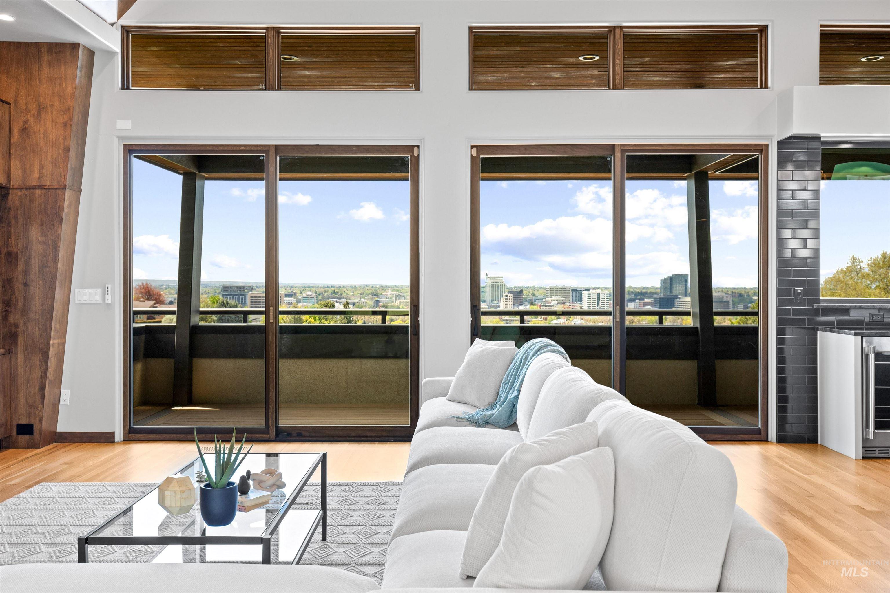 Expansive glass sliding doors open to a balcony, complemented by transom windows above