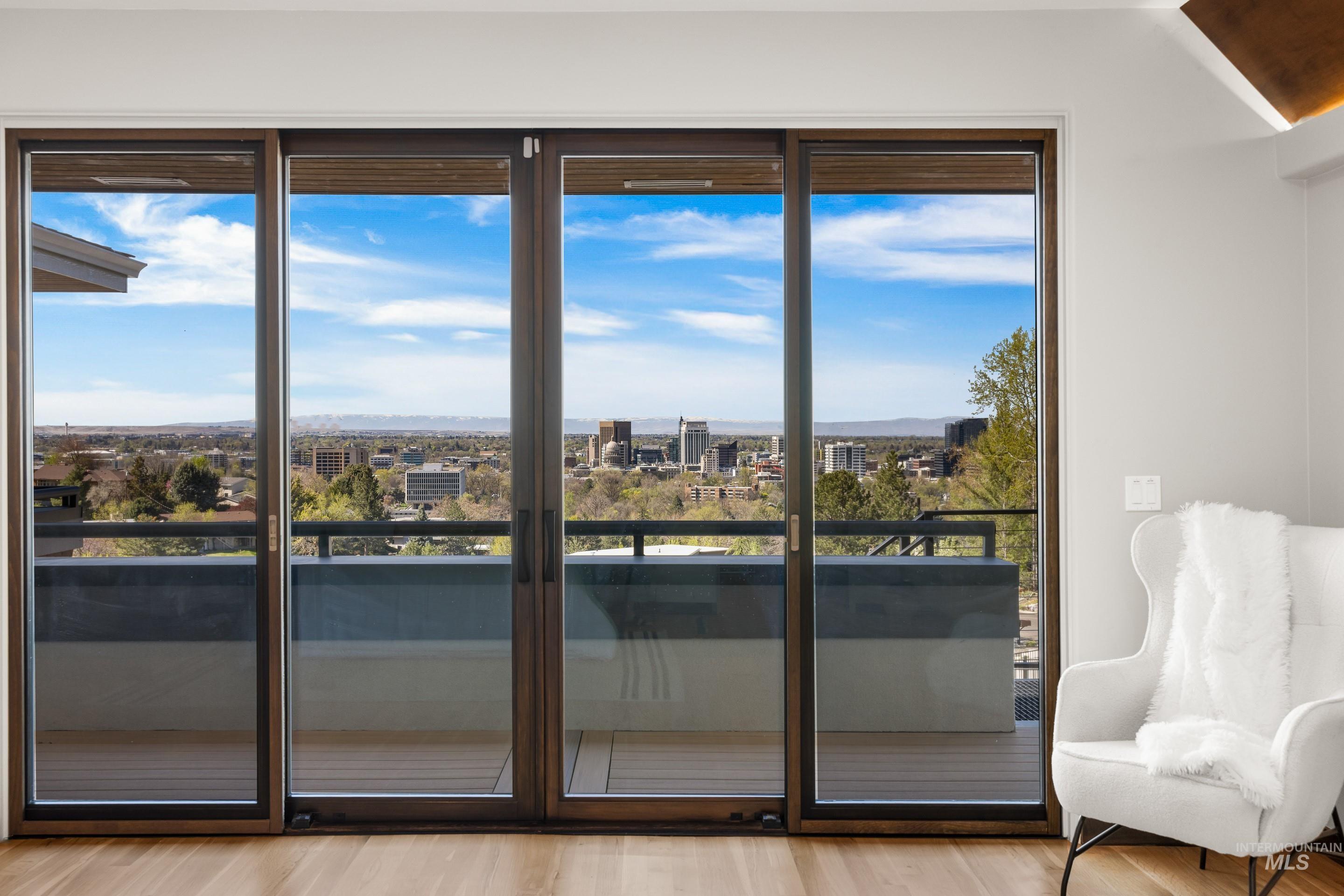 Expansive sliding glass doors opening to a private balcony