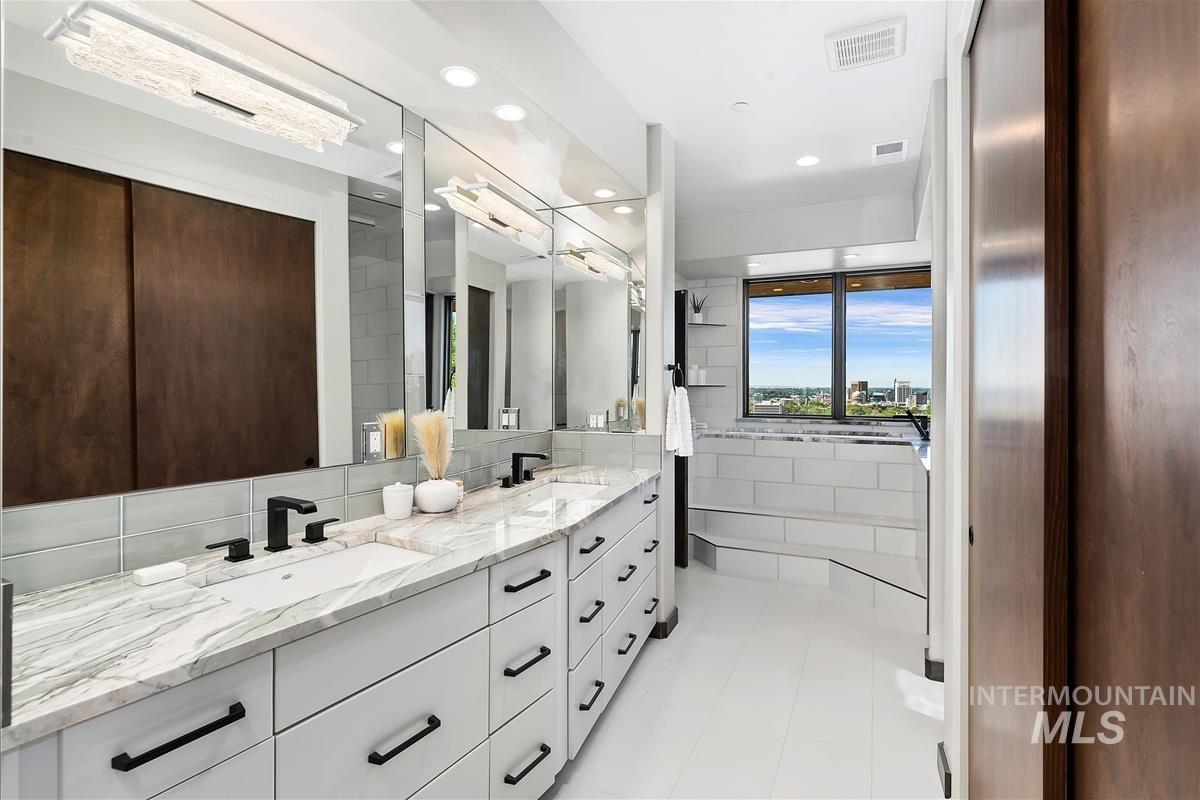 Dual vanity with stone countertops and undermount sinks