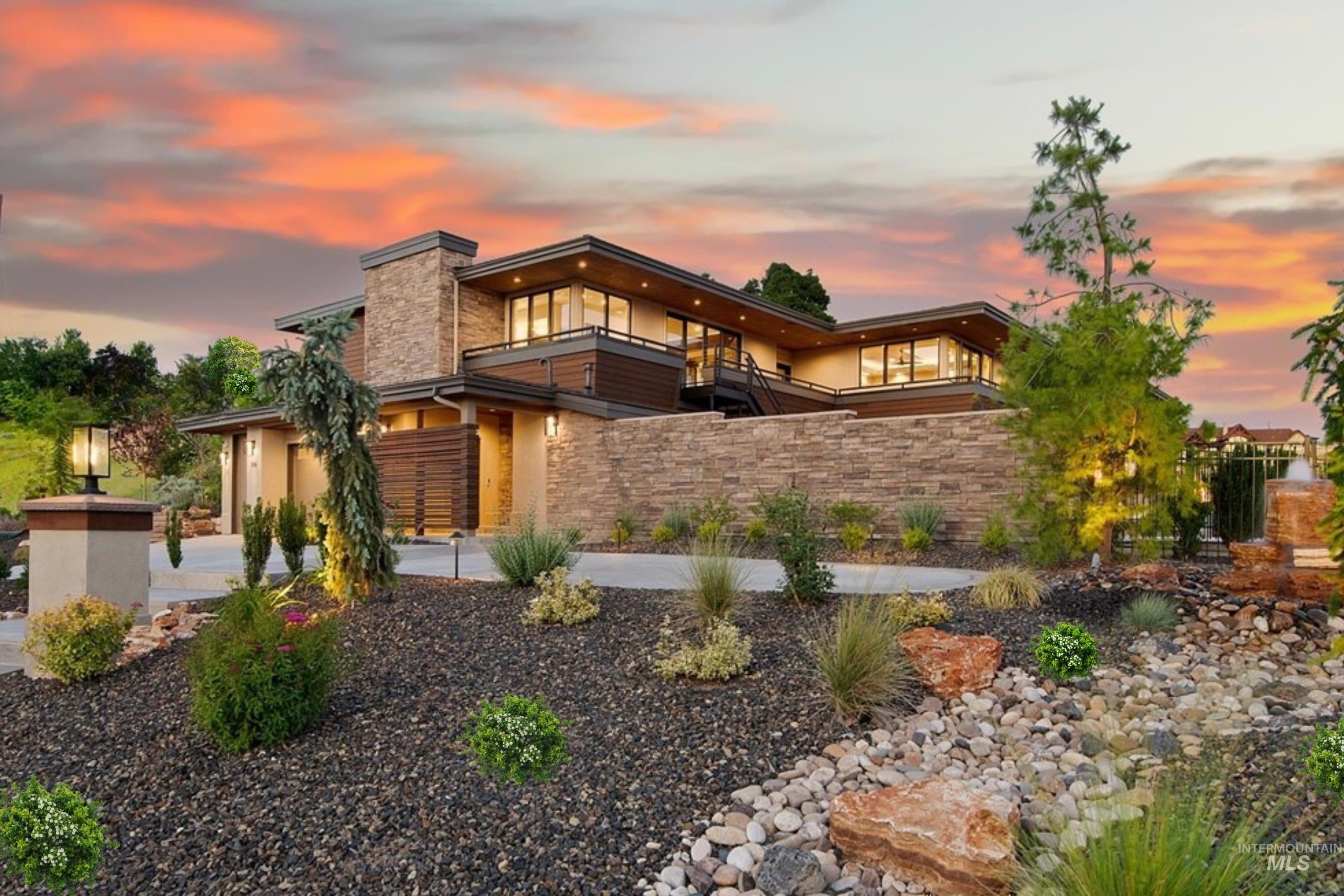 Contemporary architectural residence featuring a stone and stucco exterior