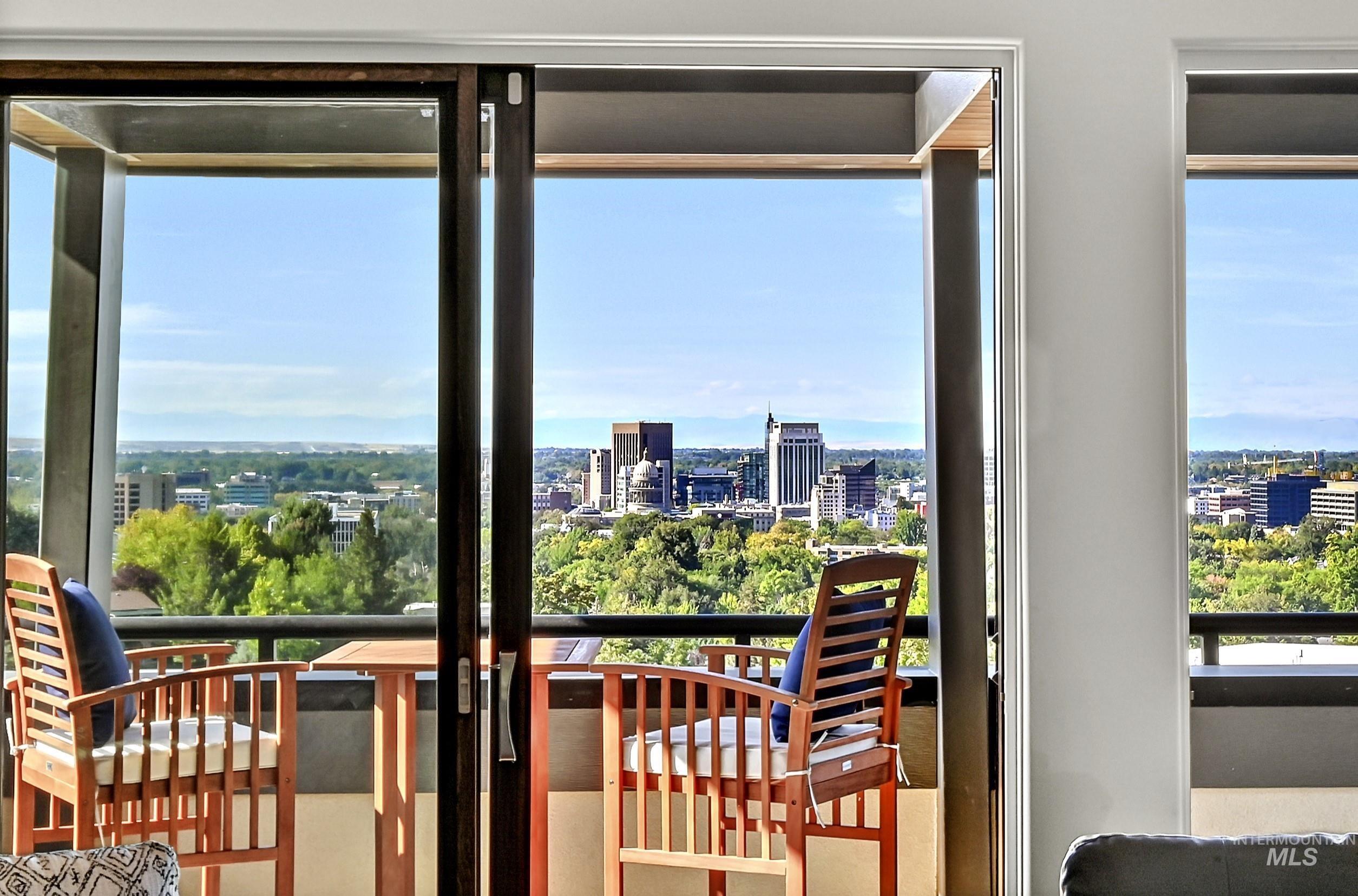 Expansive glass sliding doors open to a private balcony