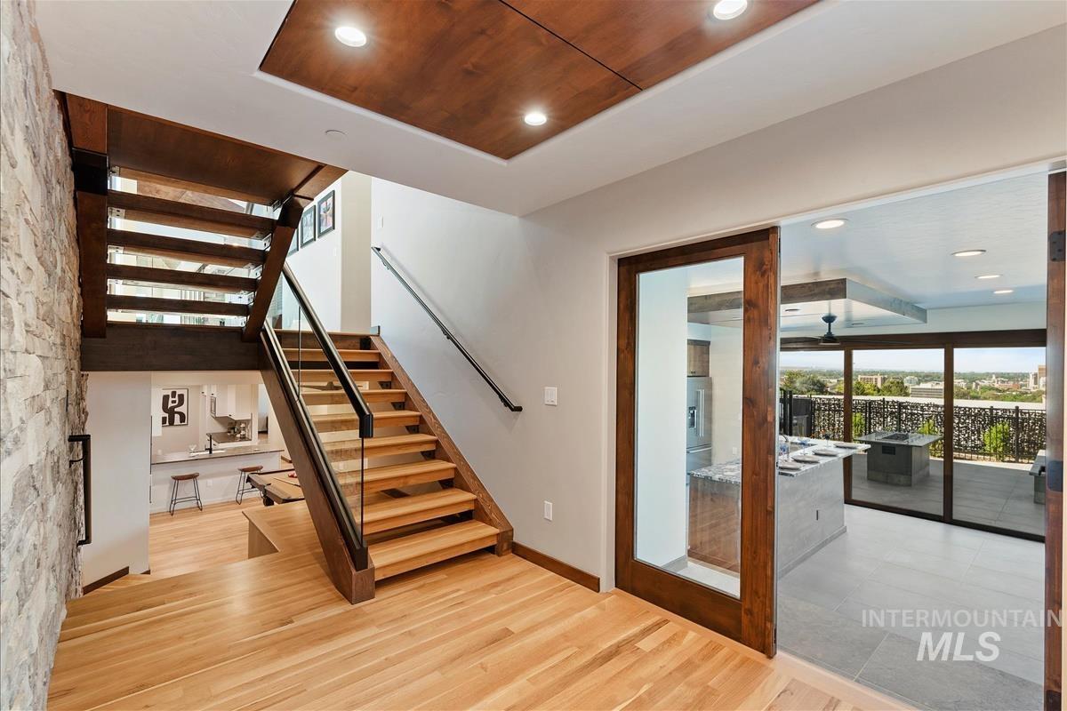 Hardwood flooring extends throughout this space, complemented by a stone accent wall