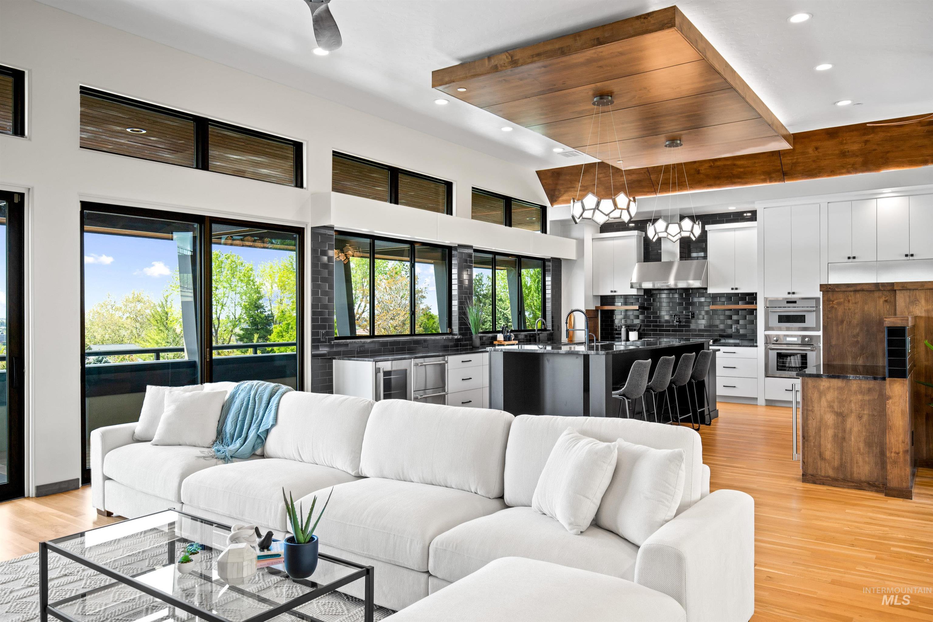 Open concept living area featuring a gourmet kitchen with a large island and integrated appliances
