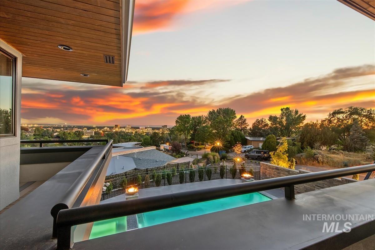 Outdoor balcony featuring a wood-finish ceiling, recessed lighting, and a metal railing