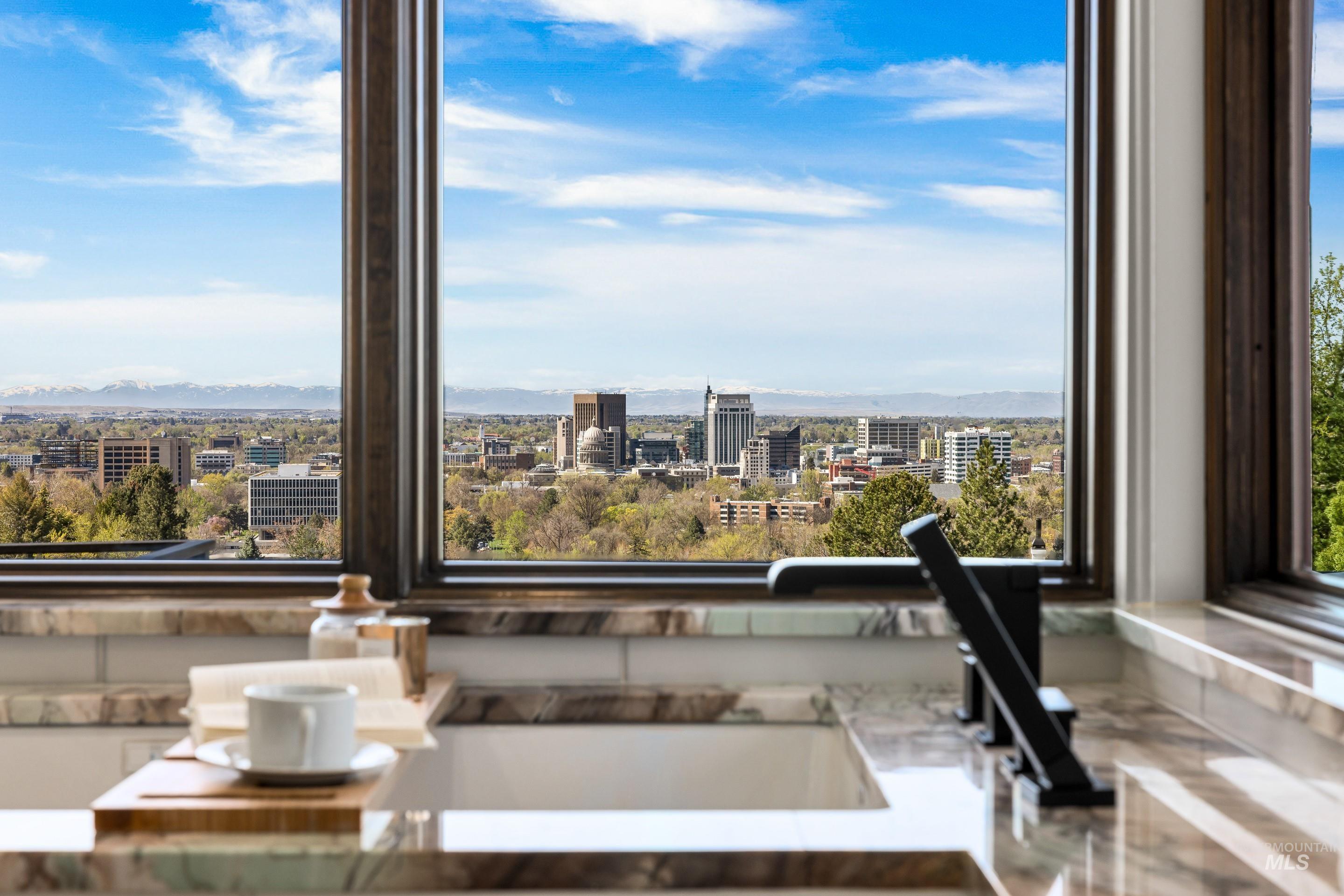 Expansive window framing city and mountain scenery