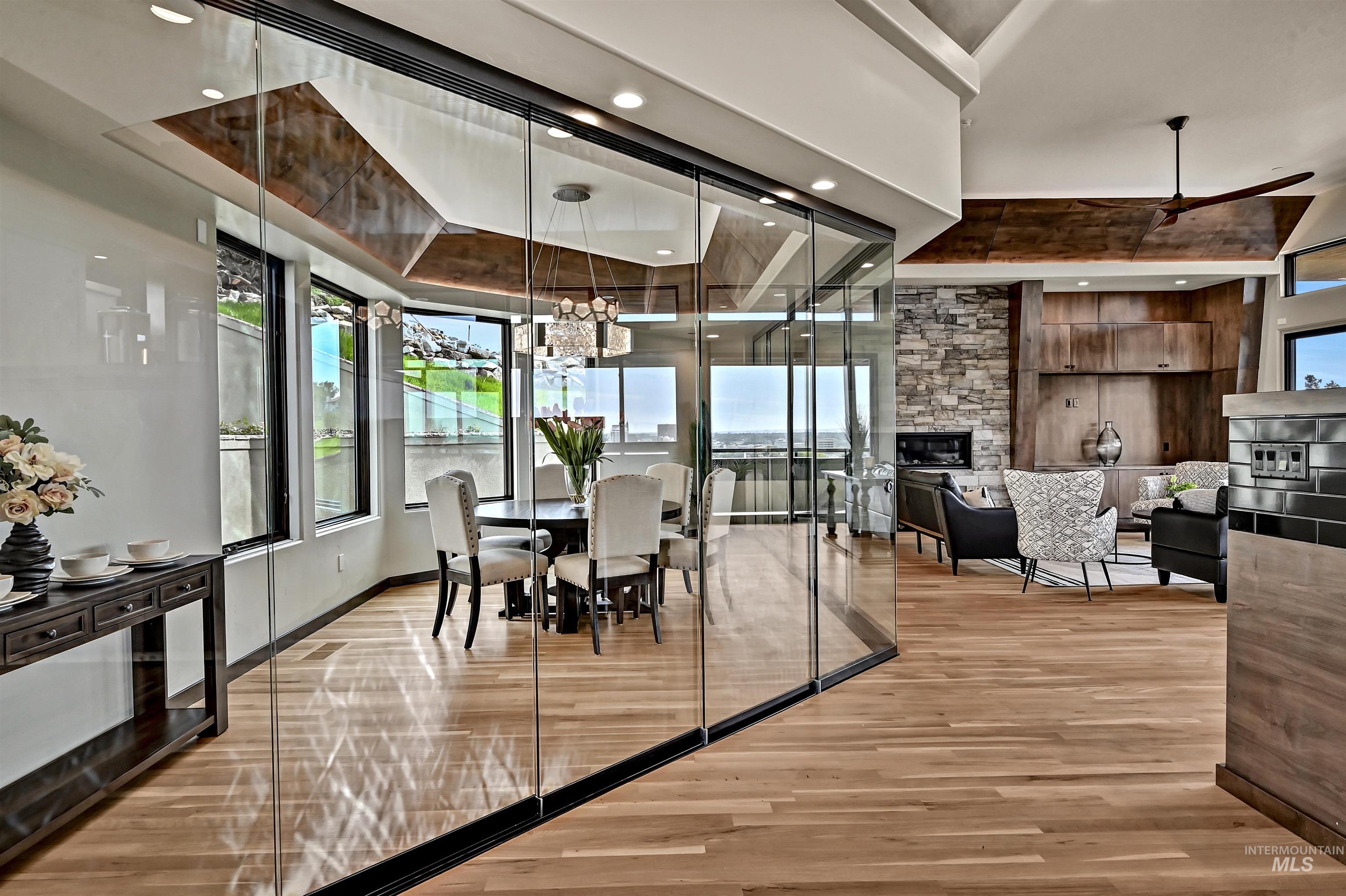 Hardwood flooring throughout the open-concept living area and enclosed dining space