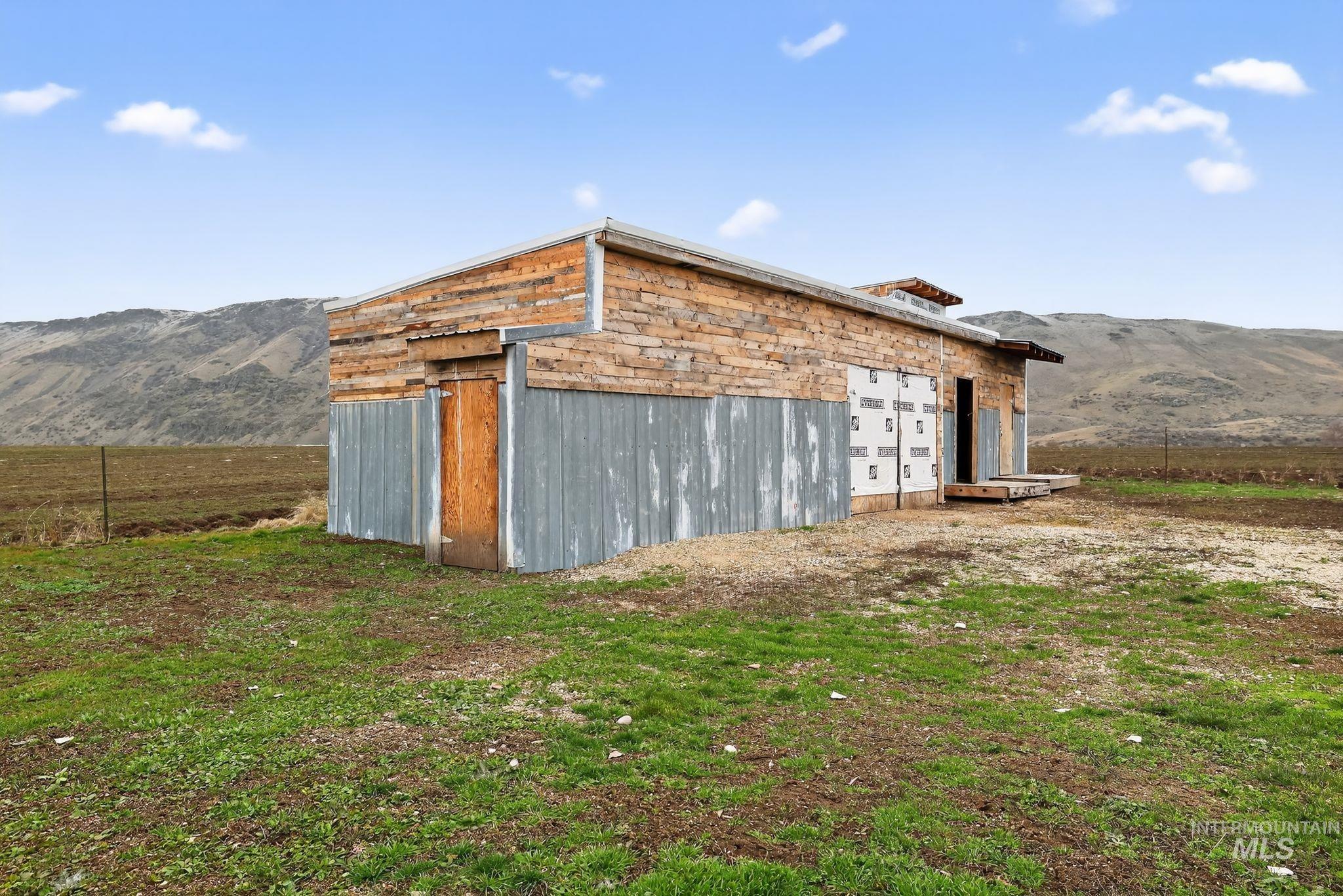 View of outbuilding featuring a mountain view and a view of countryside