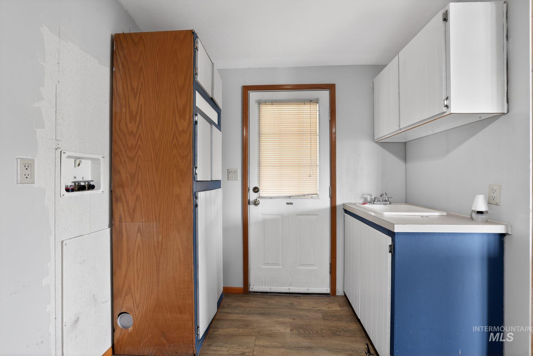 Laundry area featuring washer hookup and dark wood finished floors