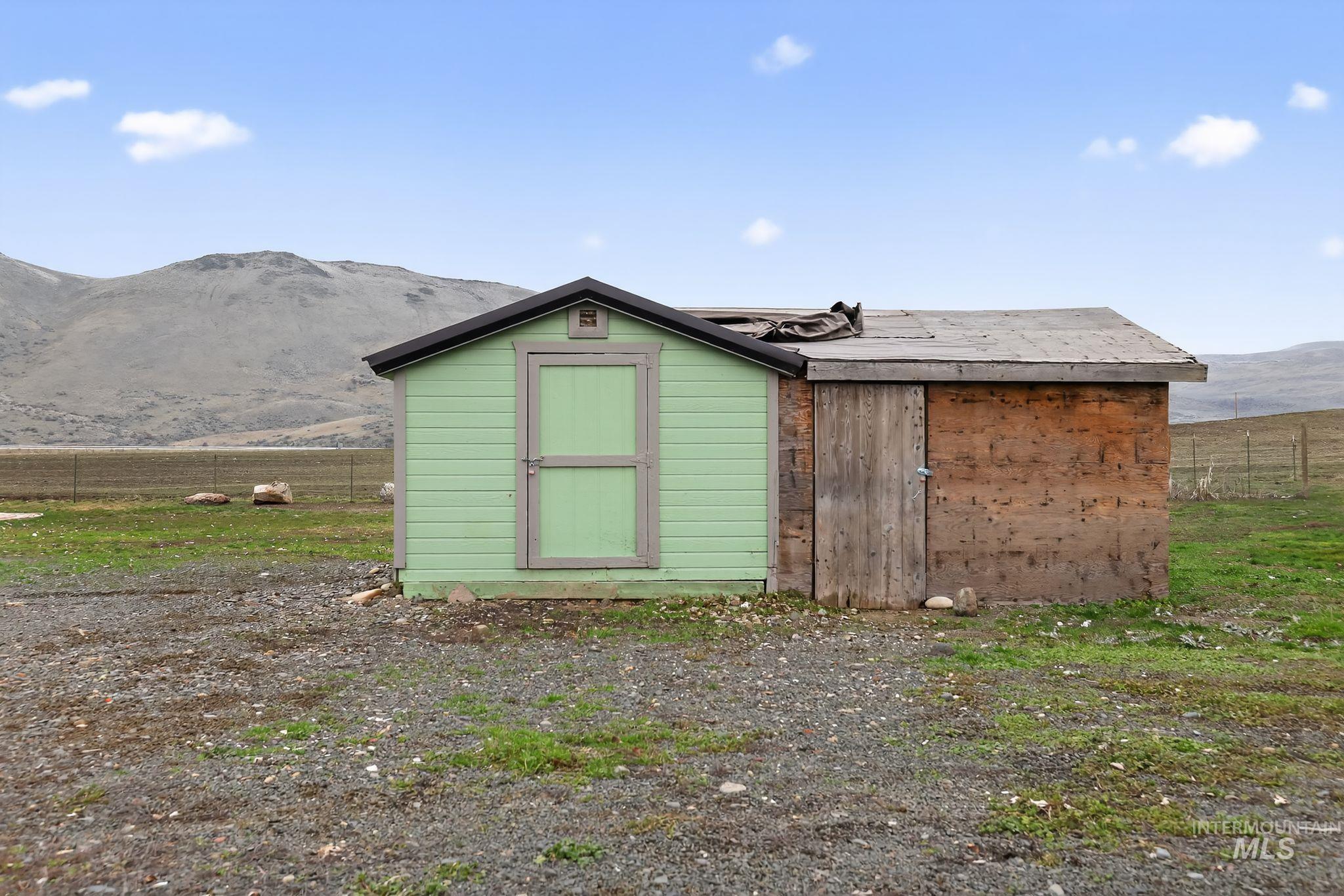 View of shed featuring a mountain view and a view of rural / pastoral area