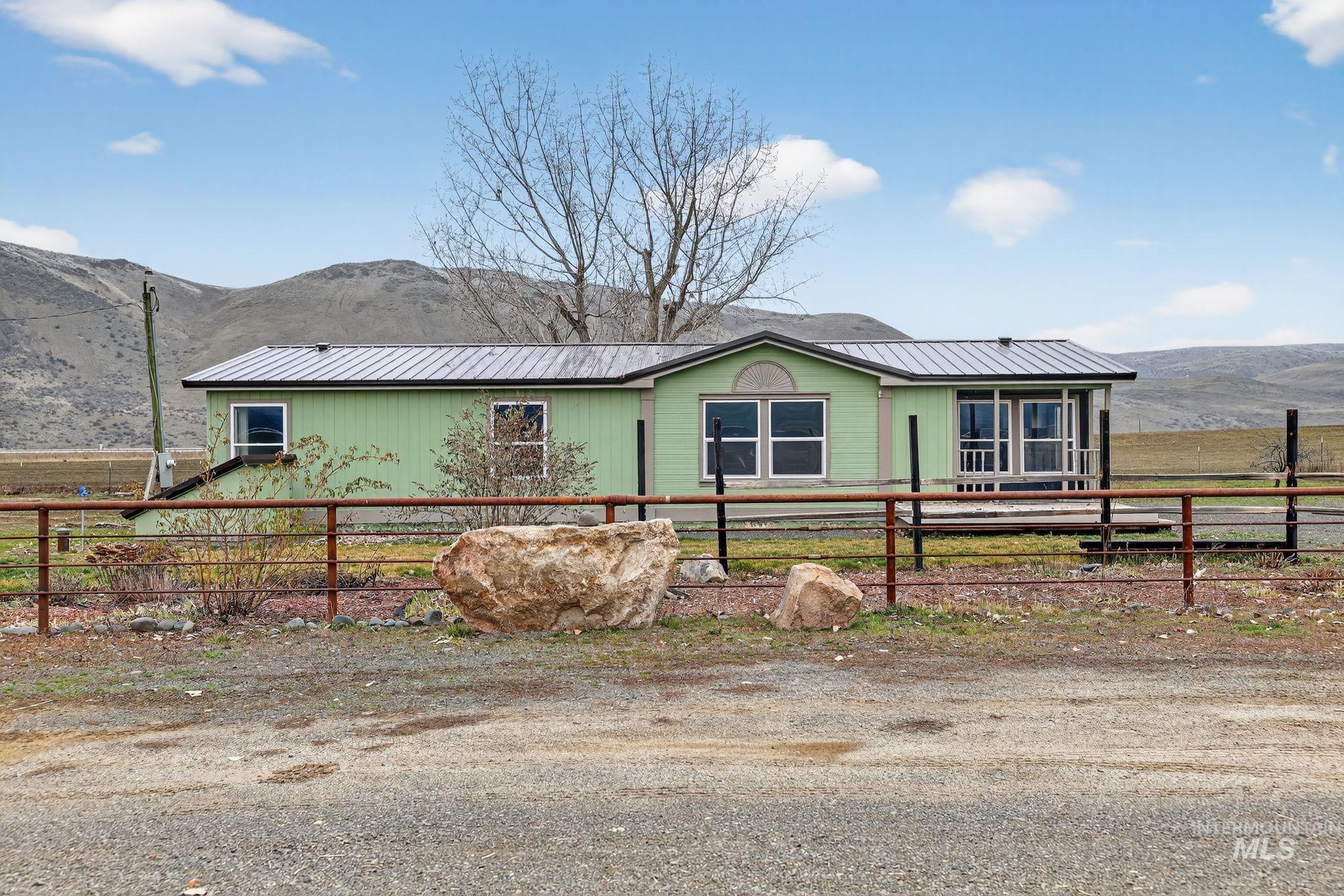 Ranch-style home featuring a mountain view and a metal roof