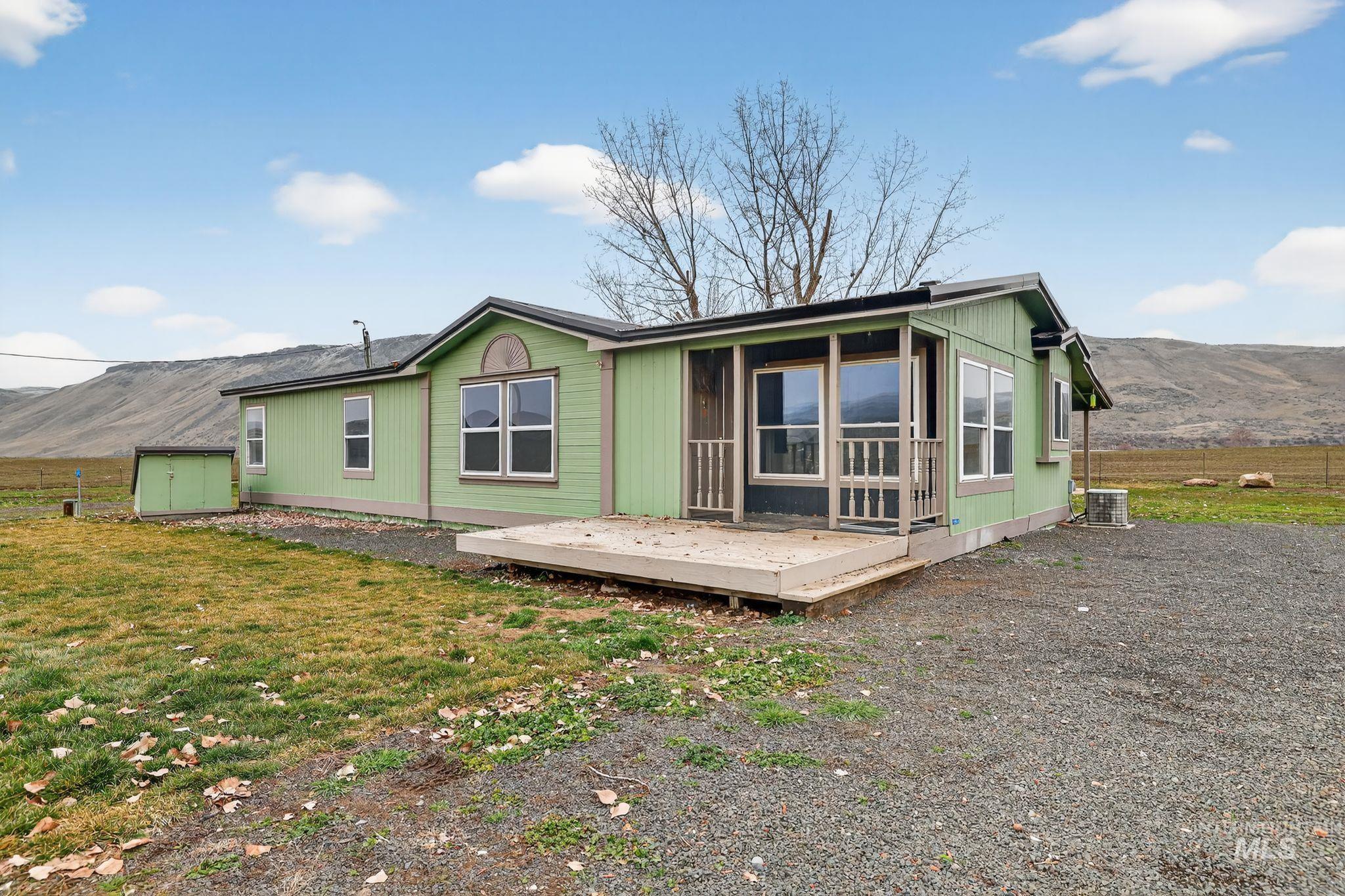 Back of property featuring a deck with mountain view