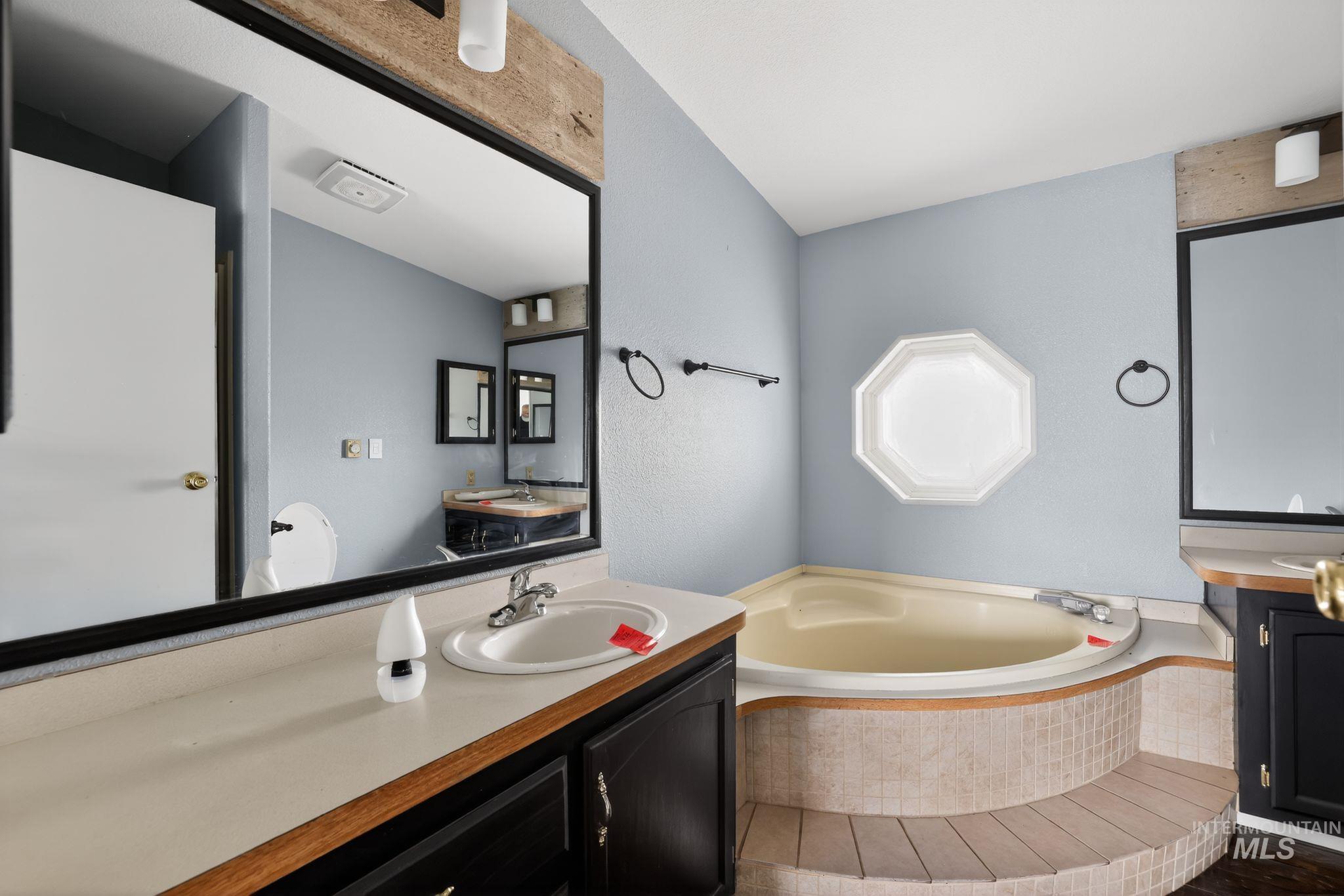 Bathroom with vanity and a garden tub
