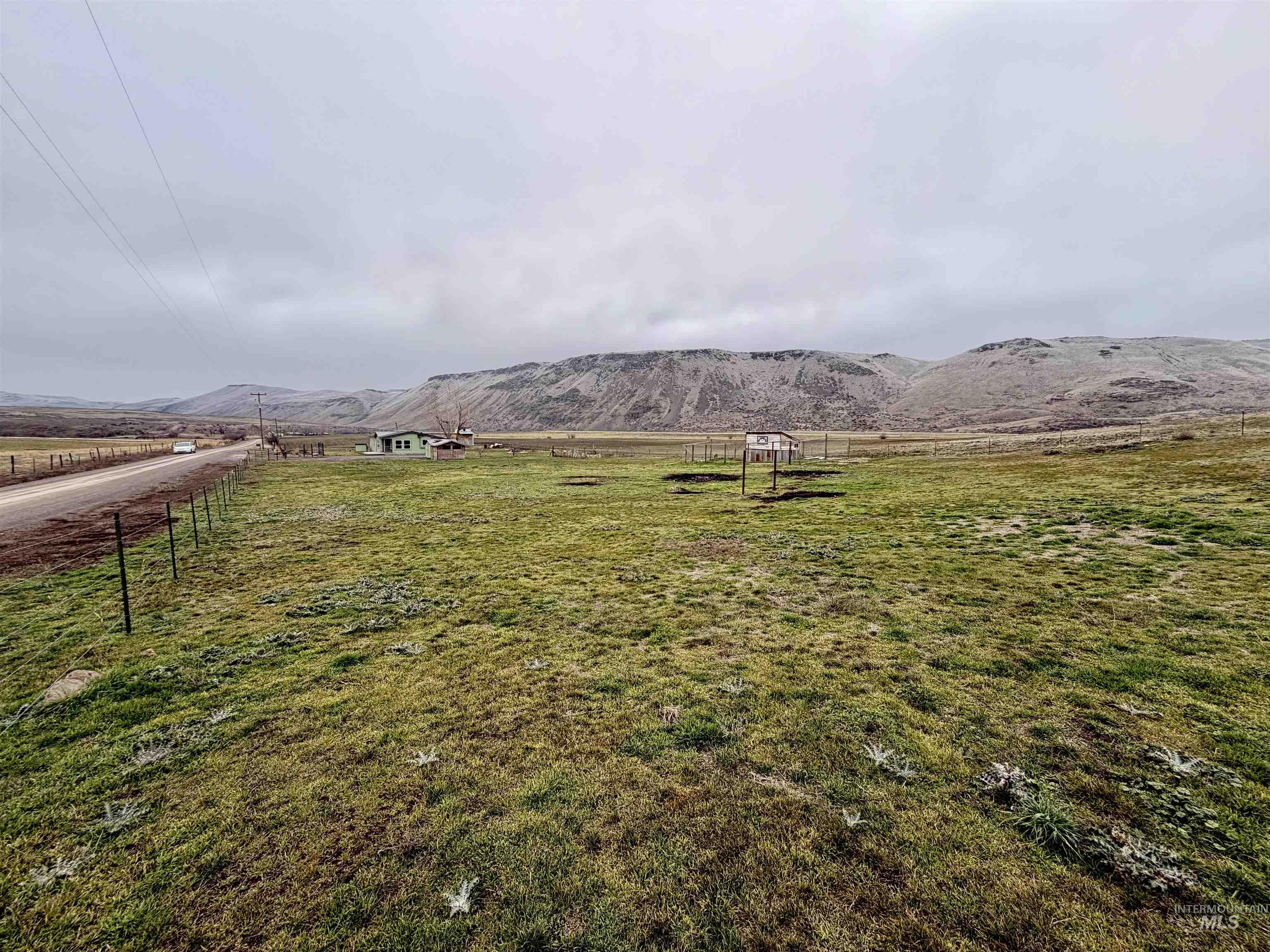 View of yard with a rural view and a mountain view