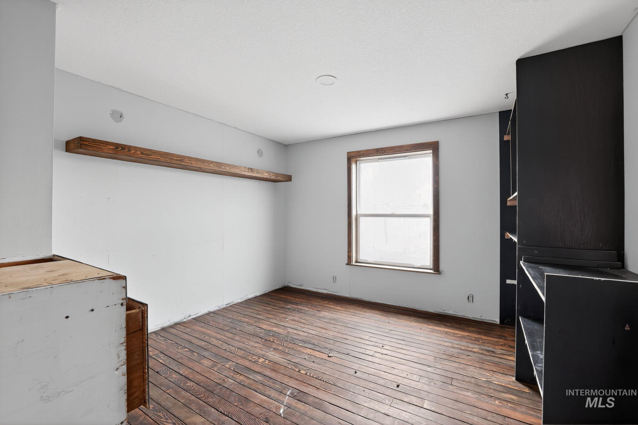 Unfurnished living room featuring hardwood / wood-style floors