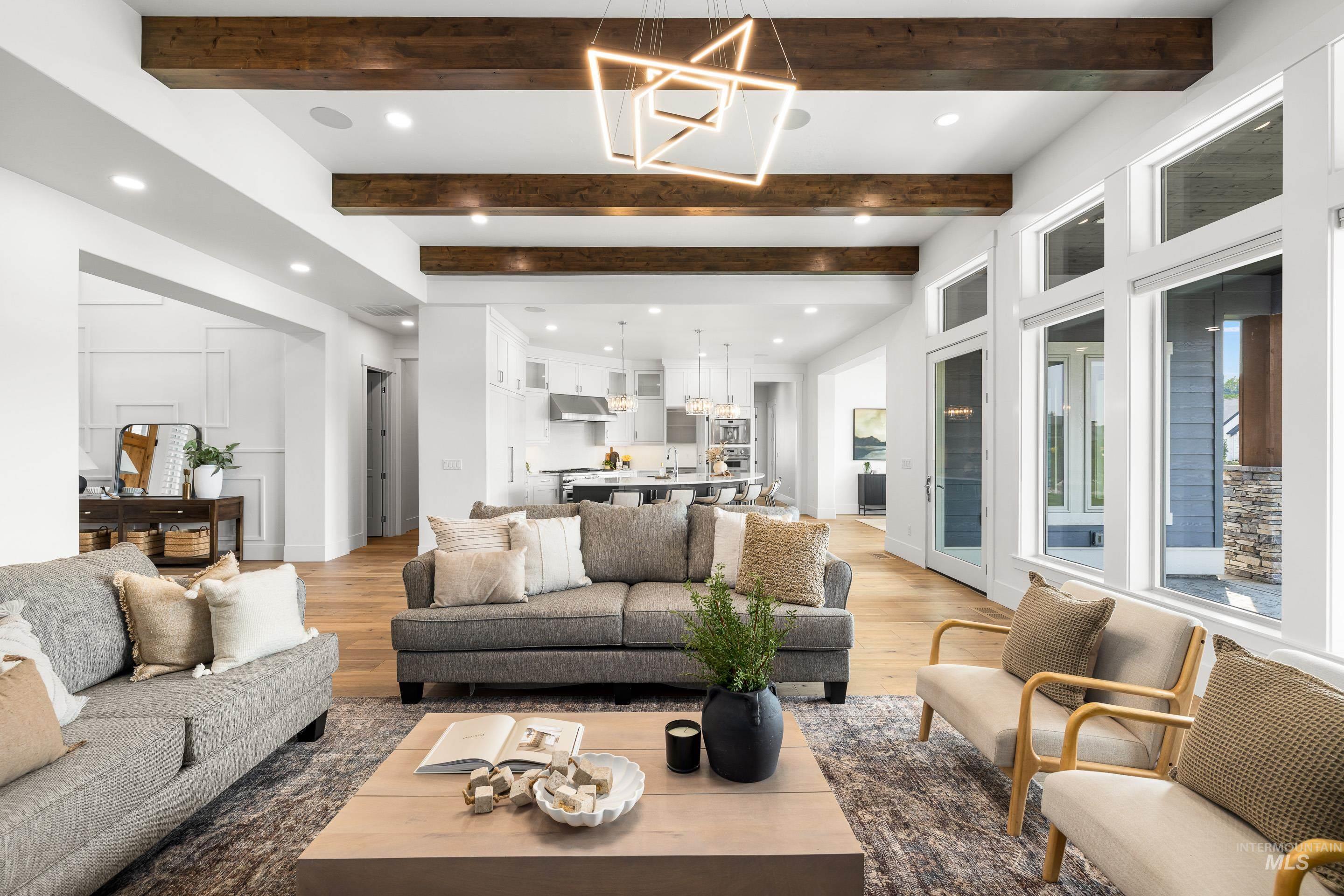 Living room featuring a chandelier, wood finished floors, beamed ceiling, and recessed lighting