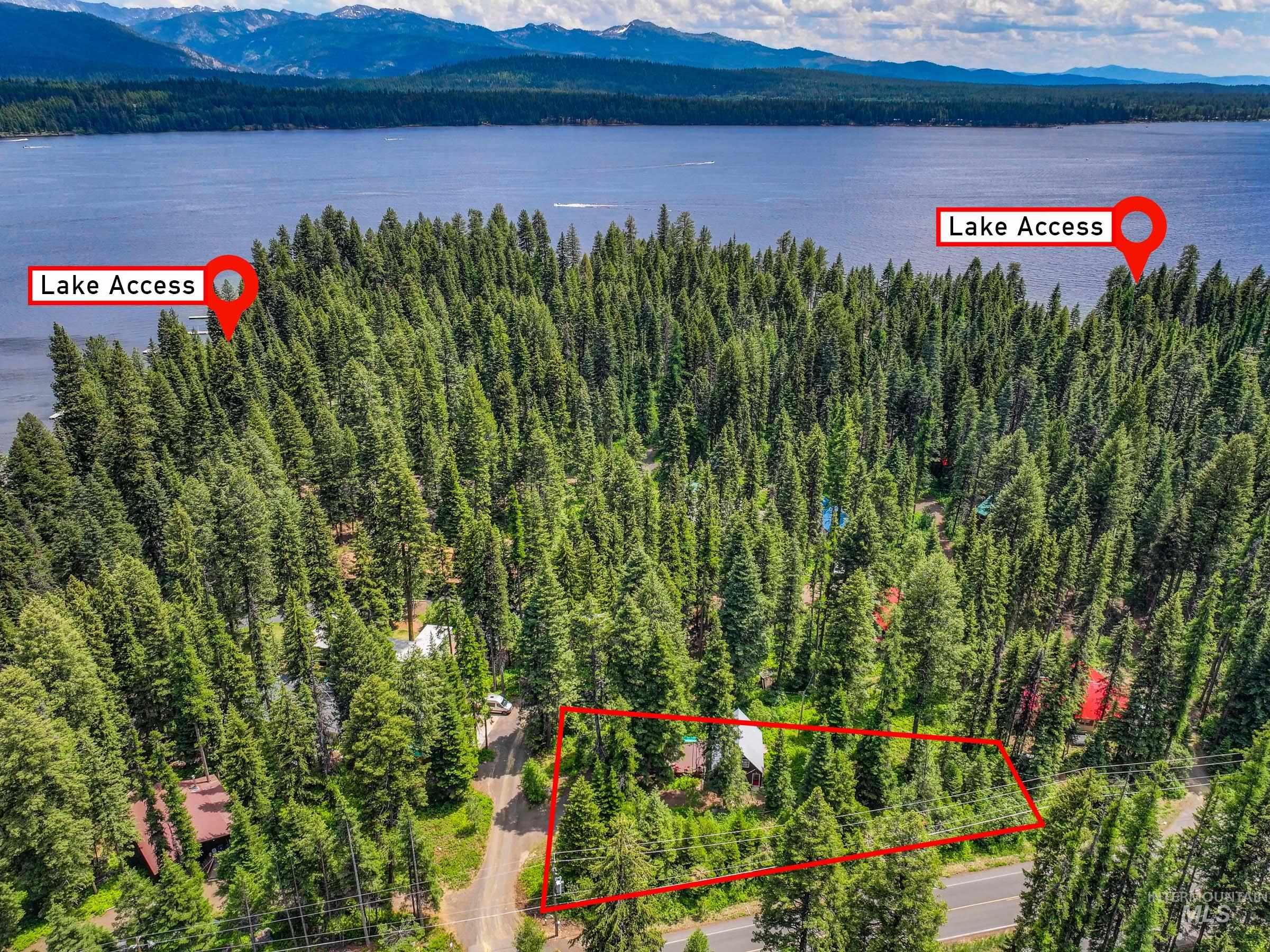 Aerial view of property's location with a water and mountain view and property parcel outlined