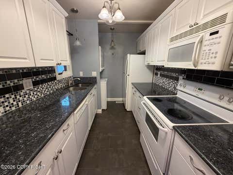 Photo of 7351 Huntsmen Circle #18G, Anchorage, AK 99518 (MLS # 26-9734)