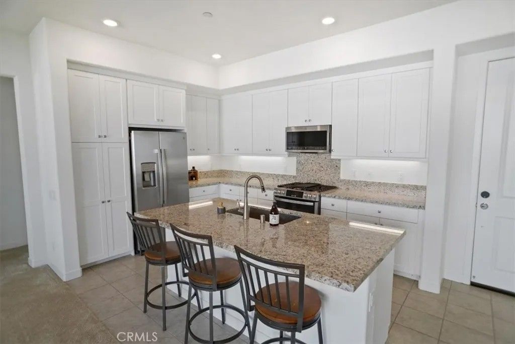 Photo of 27410 N Merlin Pl #205, Valencia, CA 91381 (MLS # SR26017263)