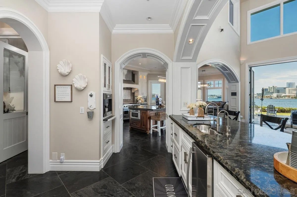 Step through the custom glass front door, etched with the San Diego sk – image 14