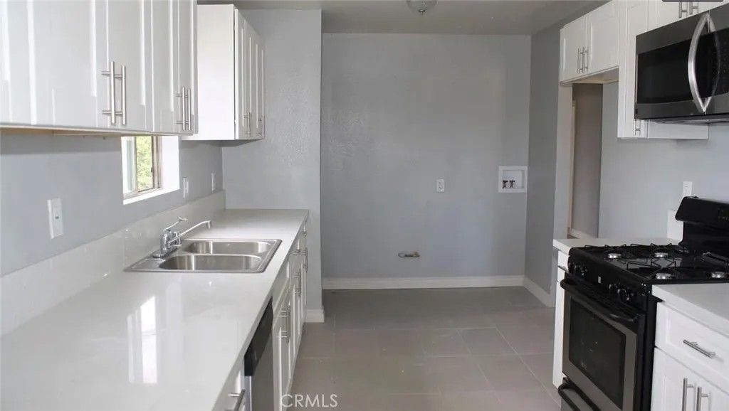 Photo of 1009 E Stockton Ave, Compton, CA 90221 (MLS # OC26064278)