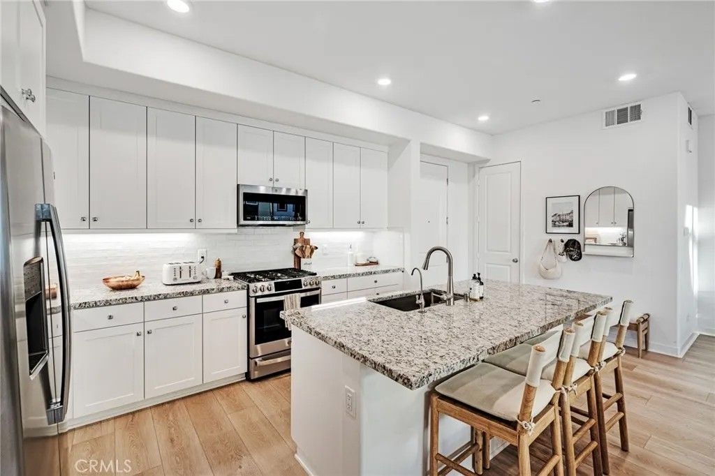Photo of 26958 Sandbar Willow Pl #205, Valencia, CA 91355 (MLS # SR26046621)