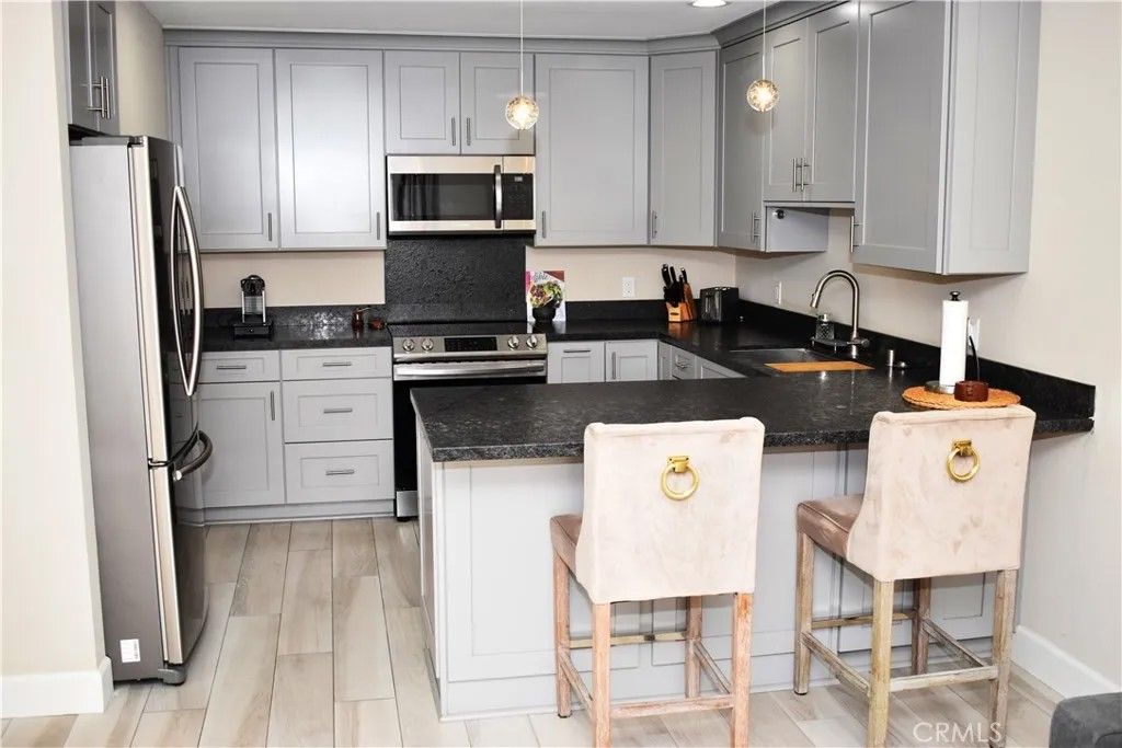 Photo of 6815 Remmet Ave #213, Canoga Park, CA 91303 (MLS # SR26043851)