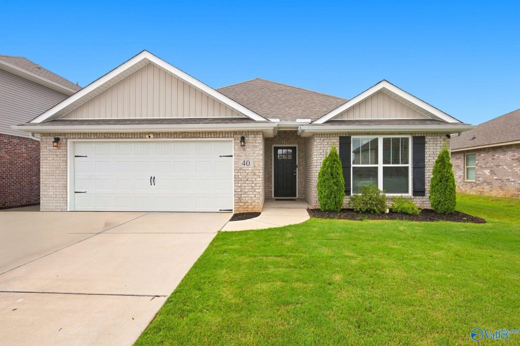 Front of 40 Sage Oak Drive, a brick ranch home with a 2-car garage