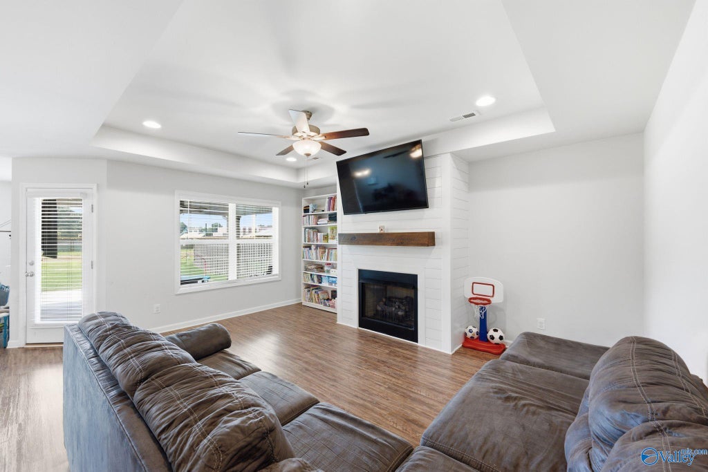 Living room with gas fireplace and ceiling fan