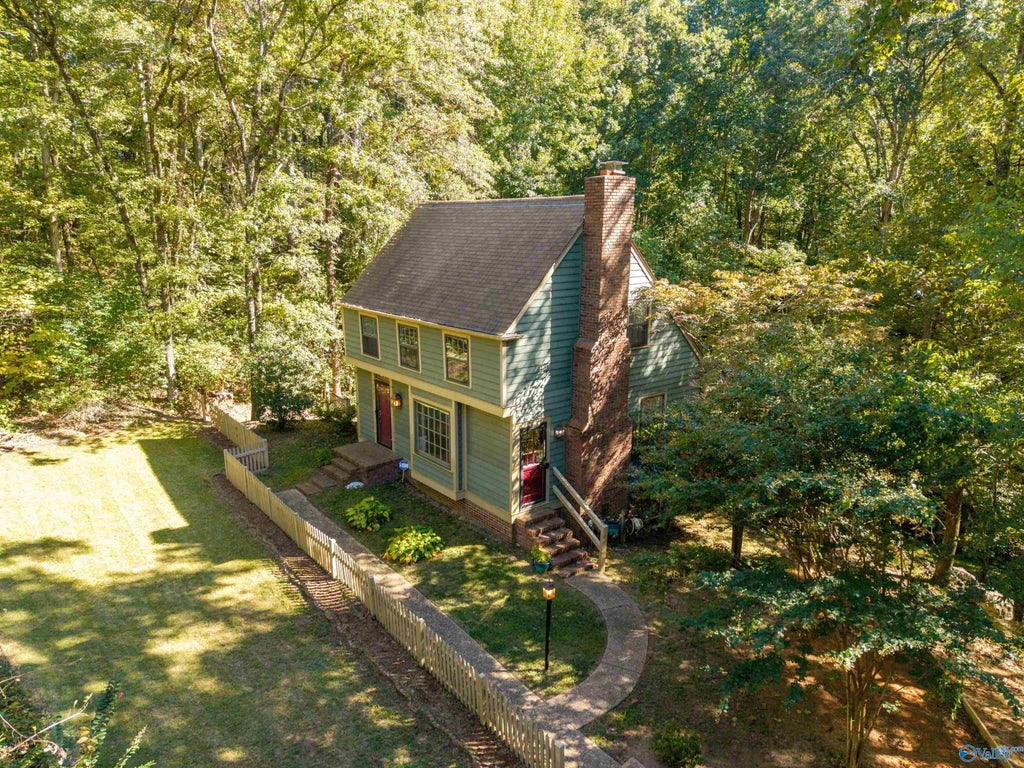 Aerial view of the home surrounded by trees