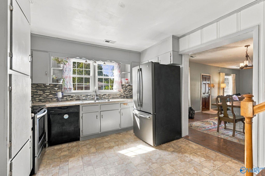 Kitchen with white cabinets and stainless appliances