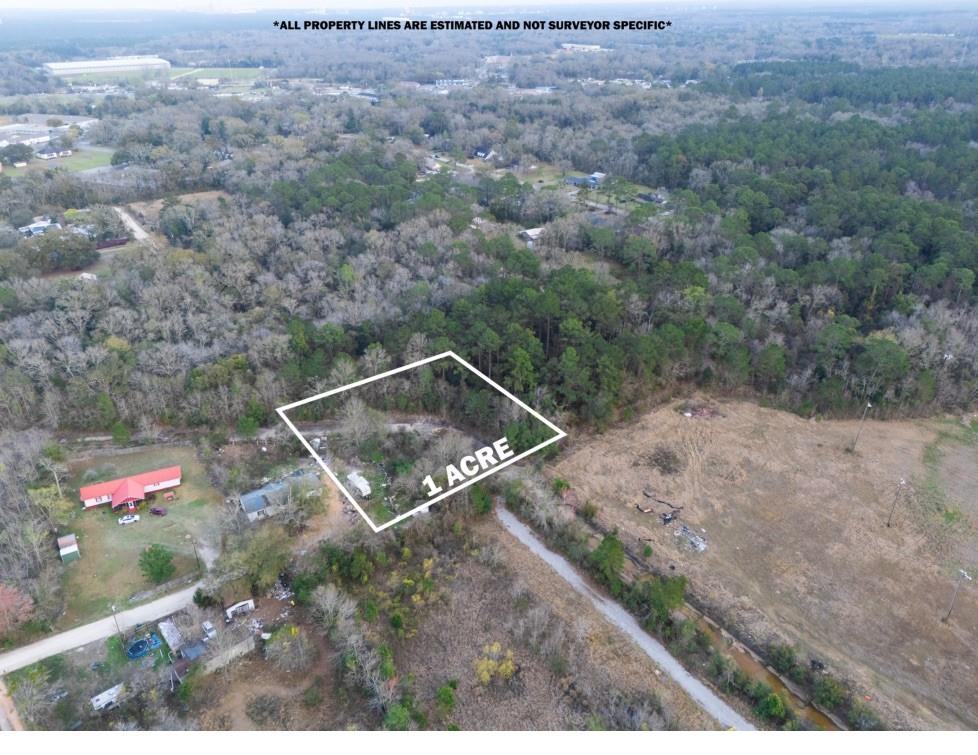 View of property location featuring property parcel outlined and a forest