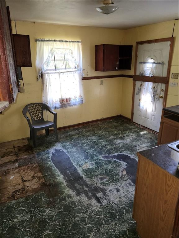 Kitchen with baseboards and dark countertops