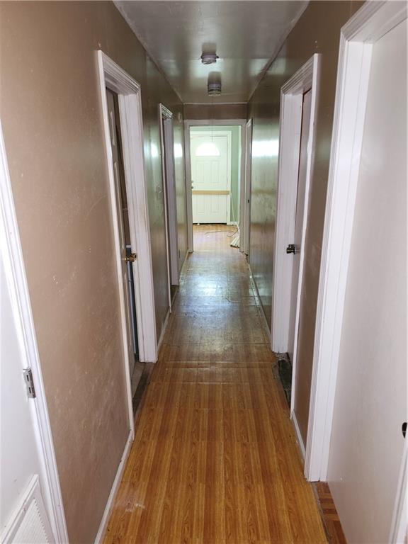 Corridor featuring light wood-style floors