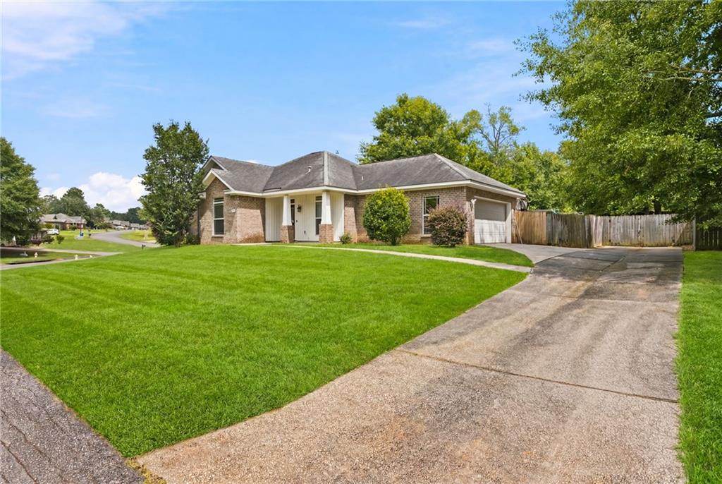 Brick exterior residence featuring a gabled roofline and an attached garage