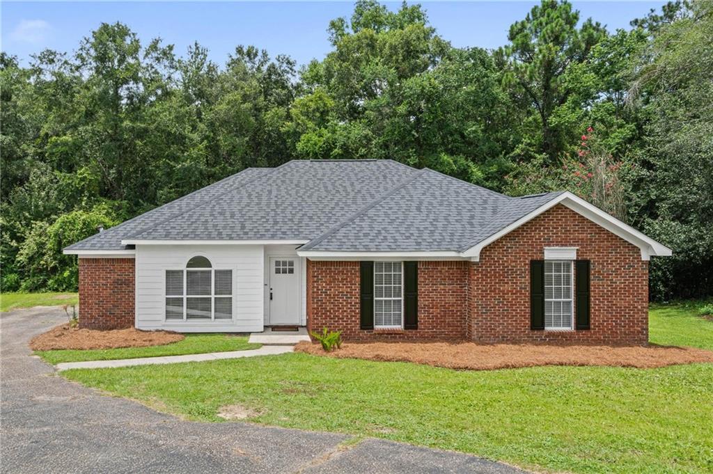Brick exterior with white siding accents and a dark gray shingle roof
