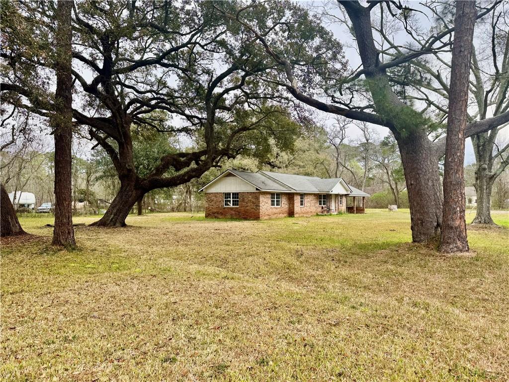 Single story home with a front yard and brick siding